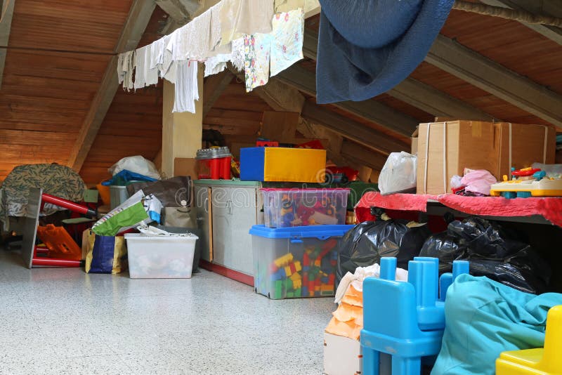 Lot of stuff and clothes hanging in the attic stock image Lot of stuff and clothes hanging in the attic stock image