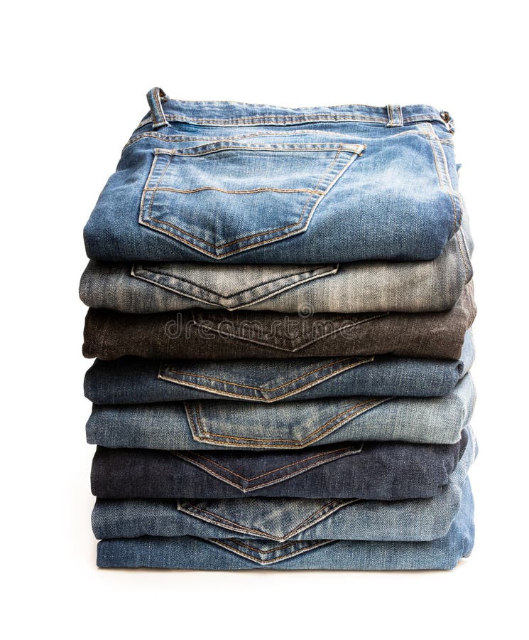 Lot Of Used Jeans Stacked In A Pile Isolated On White Stock Photo