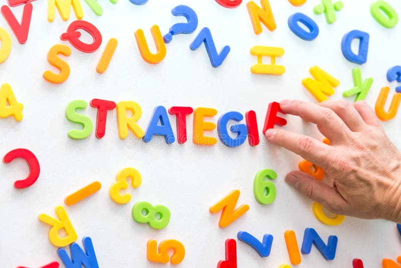 Lots of colorful letters, hand building german word, strategy royalty free stock images Lots of colorful letters, hand building german word, strategy royalty free stock images