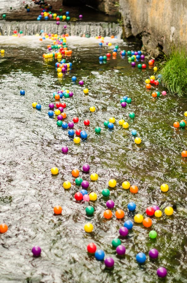Lots of Colorful Plastic Balls with Numbers in the River Stock Image