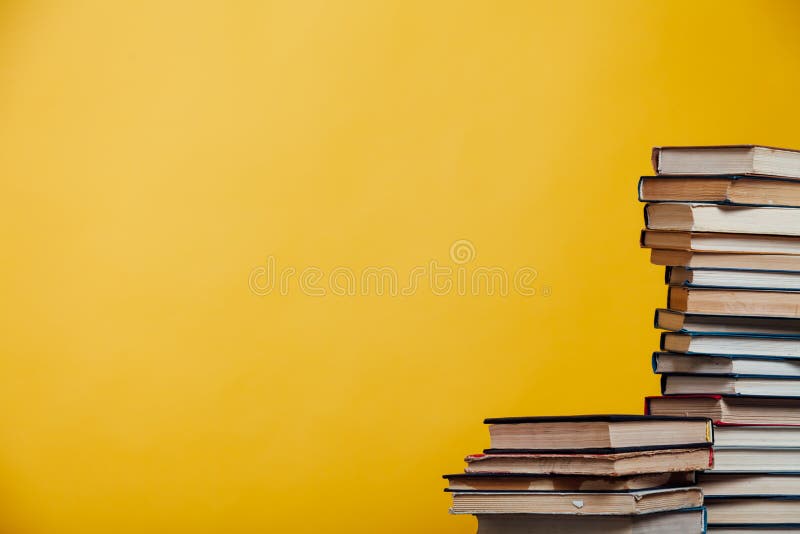 Lots of Different Educational Books on a Yellow Background Stock Photo