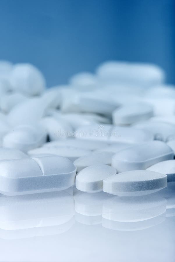 Lots of pills on blue background stock images