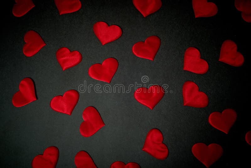 Lots of red hearts on a red background, texture.Valentine`s Day.