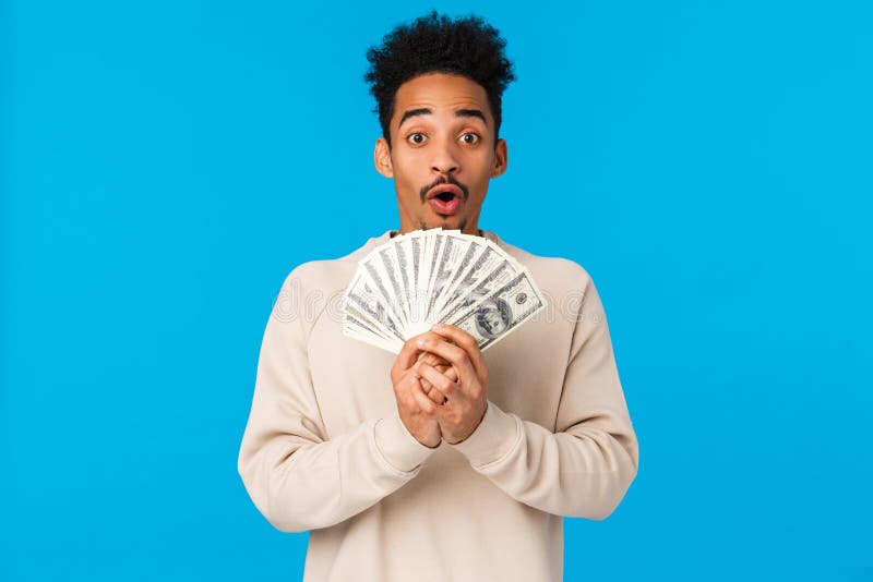 Lottery, sport bet and finance concept. Amazed and startled happy african-american guy got lots of cash, winning prize stock image Lottery, sport bet and finance concept. Amazed and startled happy african-american guy got lots of cash, winning prize stock image
