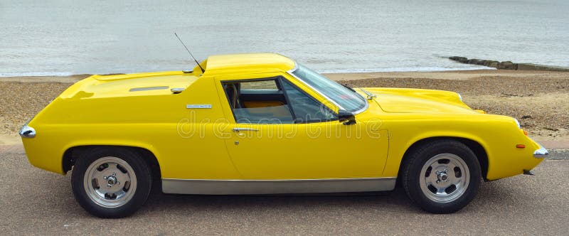 Lotus Europa Motor Car Parked gialla classica sulla passeggiata del lungonmare fotografia stock libera da diritti Lotus Europa Motor Car Parked gialla classica sulla passeggiata del lungonmare fotografia stock libera da diritti