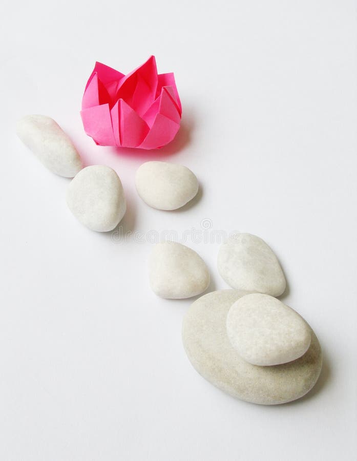 Lotus origami, white pebbles royalty free stock images