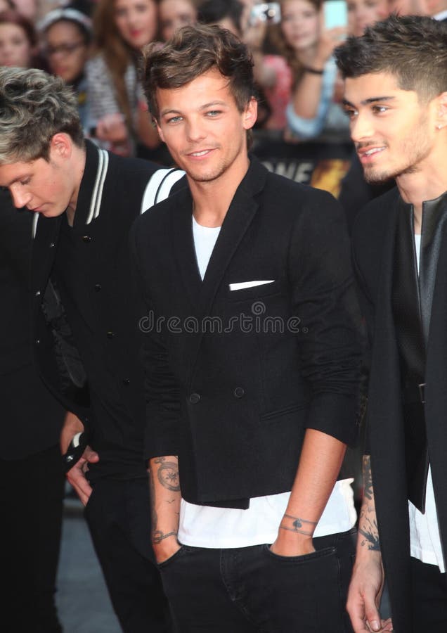 Louis Tomlinson from One Direction arriving at the UK Premiere of 'One Direction, This Is Us' at the Empire Leicester Square, London. 20/08/2013 Picture by: Alexandra Glen / Featureflash. Louis Tomlinson from One Direction arriving at the UK Premiere of 'One Direction, This Is Us' at the Empire Leicester Square, London. 20/08/2013 Picture by: Alexandra Glen / Featureflash