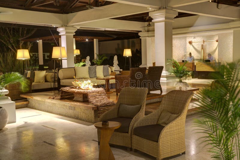 Lounge Bar Interior with Tables and Chairs and Couches at Night