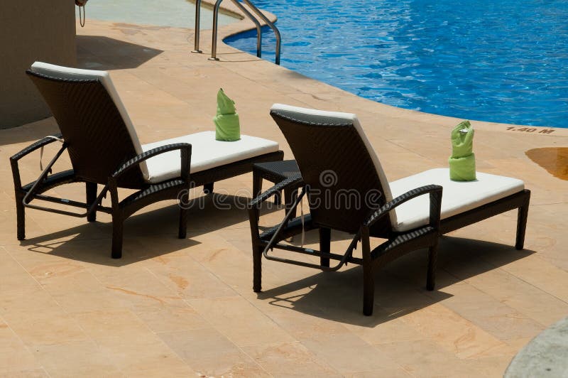 Lounge Chairs by the Swimming Pool Stock Photo - Image of chairs