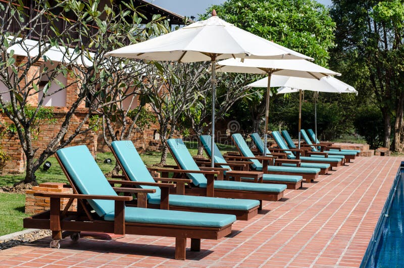 Lounge sunbed beach chairs near swimming pool stock images Lounge sunbed beach chairs near swimming pool stock images