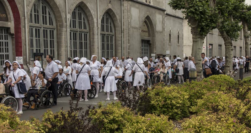 Lourdes, France June 24, 2019: Volunteers helping the sick get to the sanctuary of Our Lady in Lourdes, famous for many healings