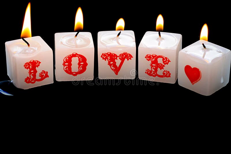 Candles spelling out the word love, isolated on black. Candles spelling out the word love, isolated on black