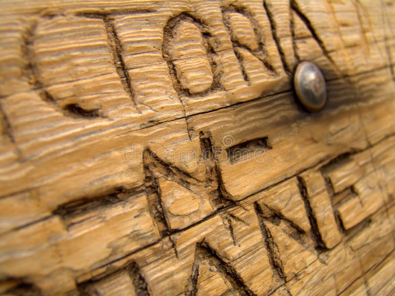 Abstract closeup of an eternal message carved into a wooden bench: victoria -n- shane. Abstract closeup of an eternal message carved into a wooden bench: victoria -n- shane