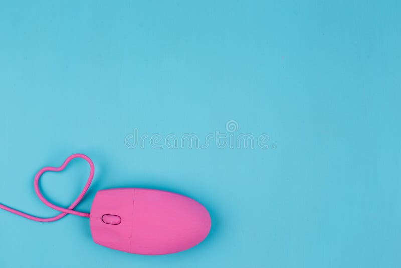 Love chat, online dating. Pink computer mouse with heart shaped wire. Love, Valentine, internet concept