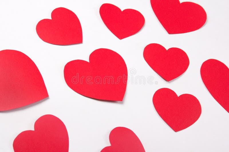 Love concept - red paper hearts over white background