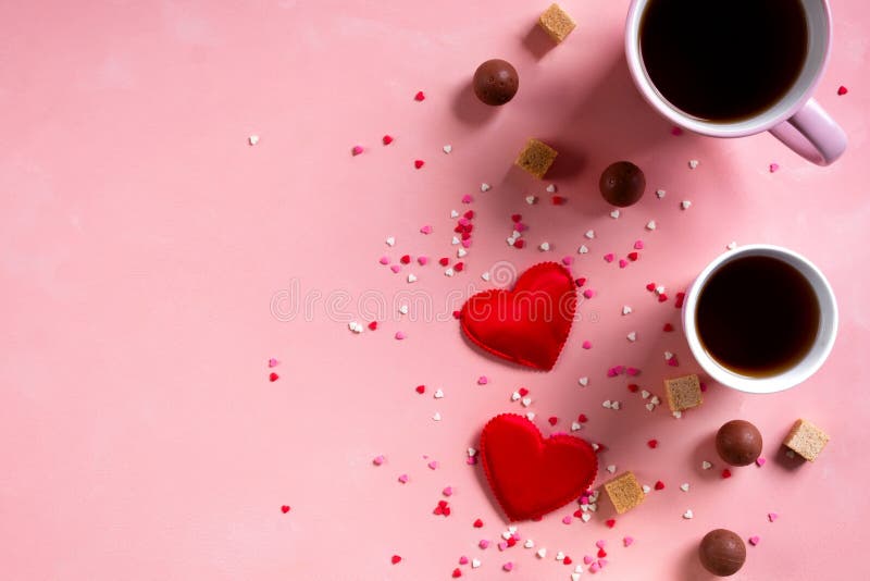 Love drinks. Coffee tea cups, sweets candy chocolate on pink hearts background. Valentines day 14 february minimal