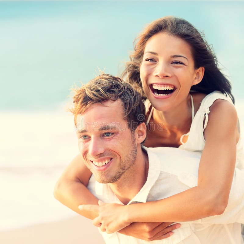 Love - Happy couple on beach having fun piggyback royalty free stock photo Love - Happy couple on beach having fun piggyback royalty free stock photo