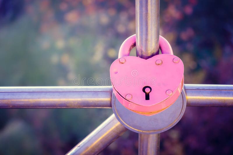 Love. A heart. The lock is tightly closed on the handrail as a sign of eternal love. Valentine s Day.