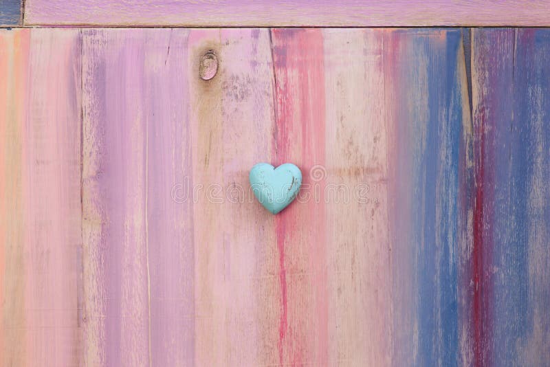 Love message space on colorful painted board with blue wooden heart and copy space. Love message space on colorful painted board with blue wooden heart and copy space