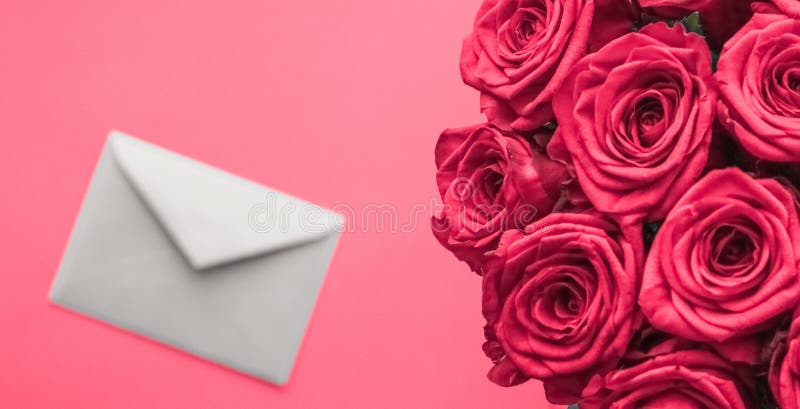 Love letter and flowers delivery on Valentines Day, luxury bouquet of roses and card on pink background for romantic holiday stock photography Love letter and flowers delivery on Valentines Day, luxury bouquet of roses and card on pink background for romantic holiday stock photography