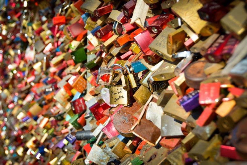 Love locks, a couple in the crowd stock photo Love locks, a couple in the crowd stock photo