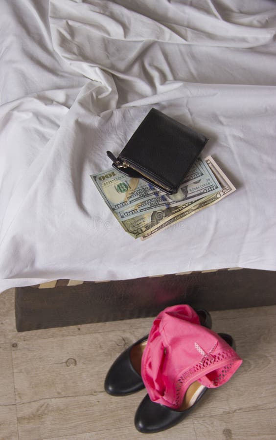Love for money is prostitution. Crumpled bed, underwear and money as payment for sex. stock photography Love for money is prostitution. Crumpled bed, underwear and money as payment for sex. stock photography