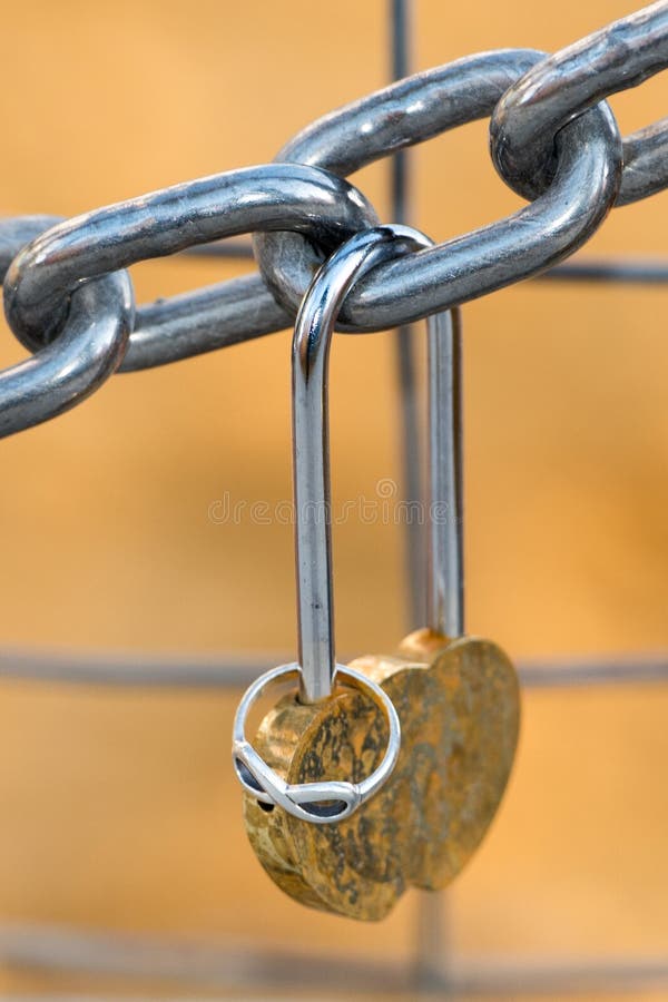 Love Padlock and Engagement Ring Hanging from a Chain Stock Image
