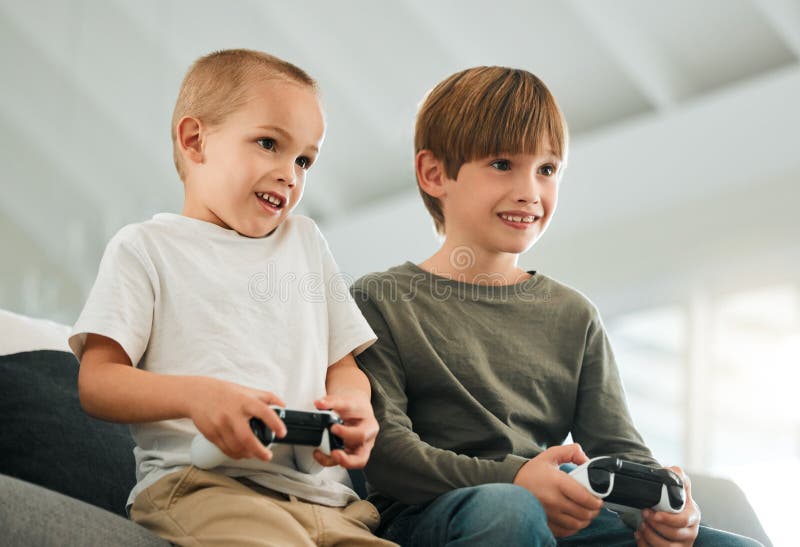 Two brothers playing video games at home. - a Royalty Free Stock Photo from  Photocase