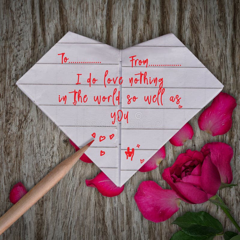 Love Quotes in Origami paper white heart, pencil and rose pink flower on wooden table background.