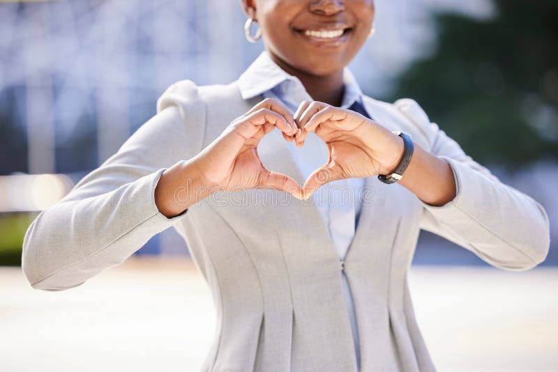 Love and a smile, a business woman makes a heart sign with her hands. Black, corporate office worker and a gesture of