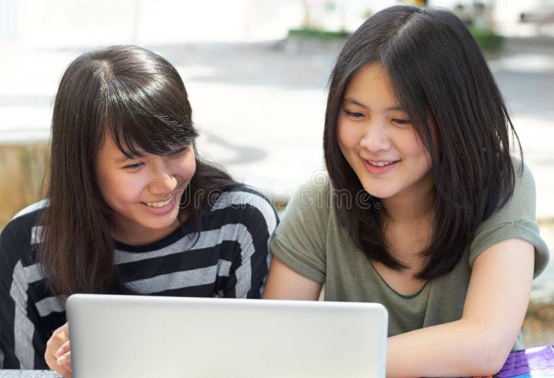 We Love University. Two Young Students Sitting Outside Together. Stock