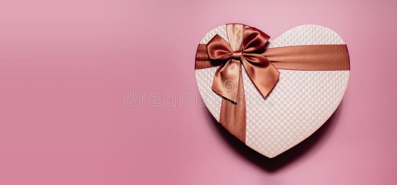 Love and Valentines Day Concept. a Golden Pink Heart Shape Gift Box. Top View
