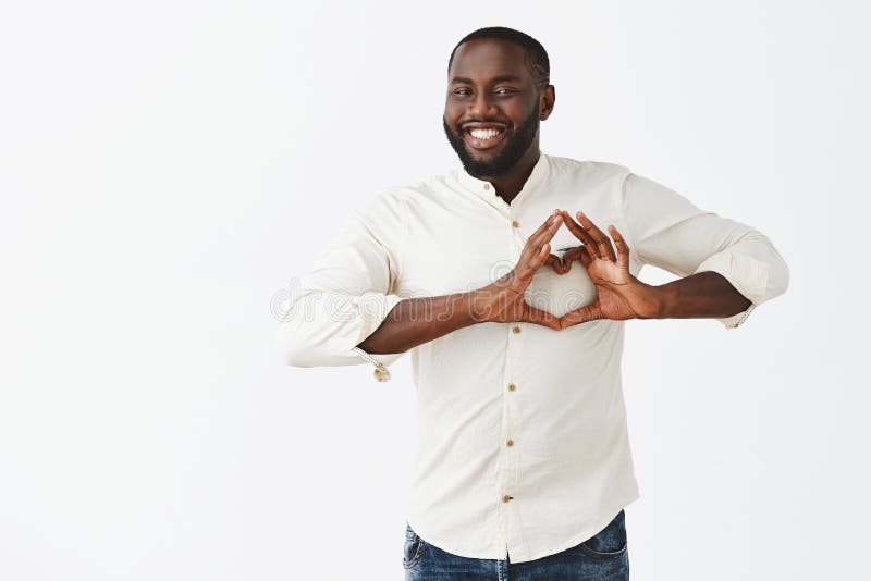 Love you all. Portrait of friendly carefree and joyful good-looking African American office worker in white shirt