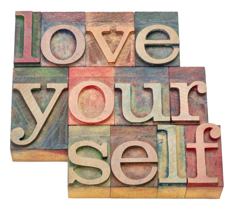 Love yourself word abstract in wood type. Love yourself - isolated word abstract in letterpress wood type blocks, self care and personal development concept