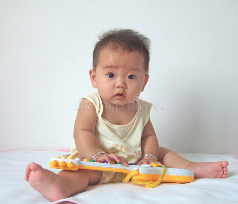 Lovely baby and toy guitar