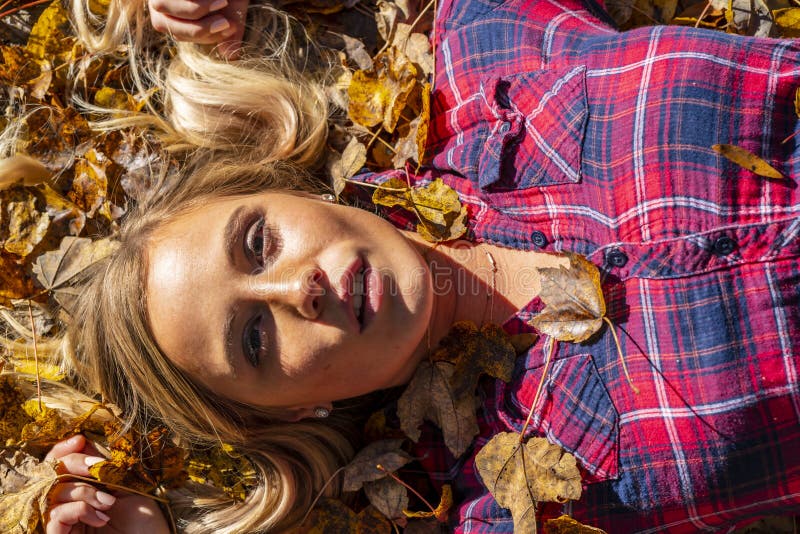 A Lovely Blonde Model Enjoys An Autumn Day Outdoors At The Park Stock