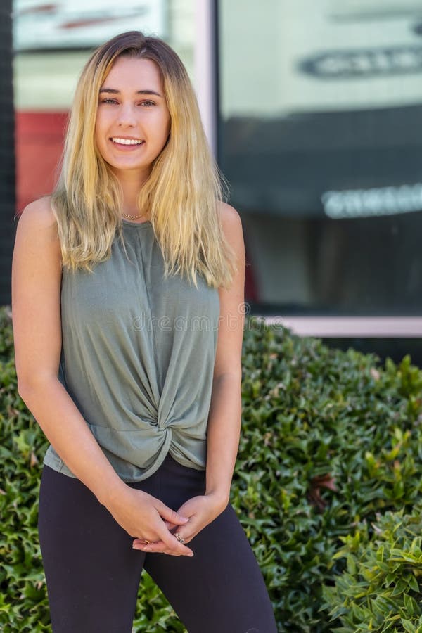 A Lovely Blonde Model Enjoys An Autumn Day Outdoors In A Small Town