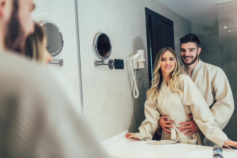 Couple In Front Of The Mirror While Getting Ready In The Bathroom Stock Image Image Of People