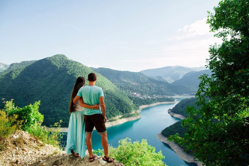 Lovely couple relax on peak of mountains