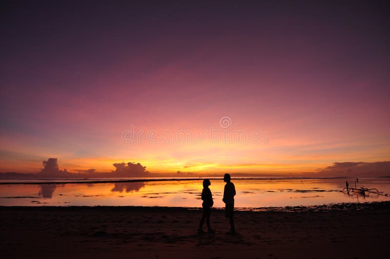 Lovely Couple with Sunrise at Balinese Beach.