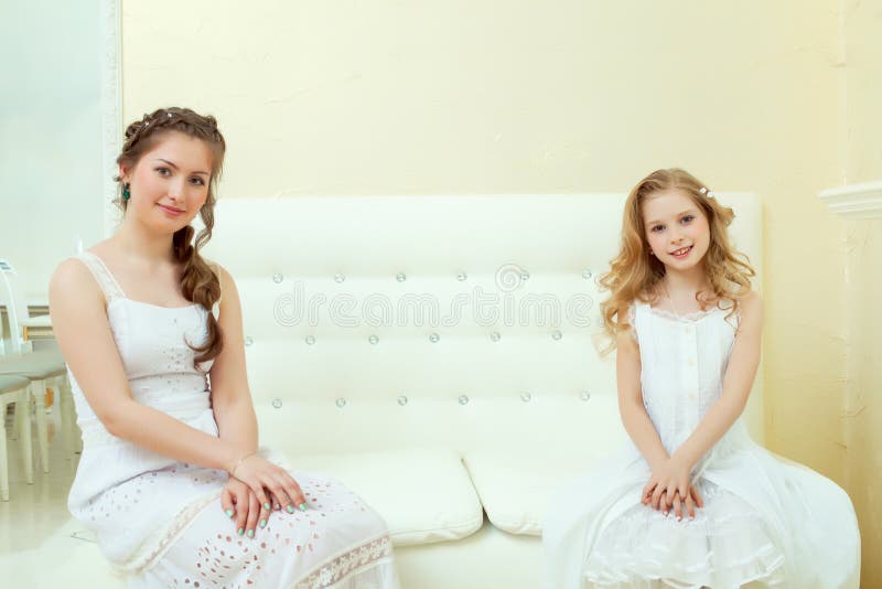 Lovely Elegant Sisters Sitting on White Couch Stock Image - Image of ...