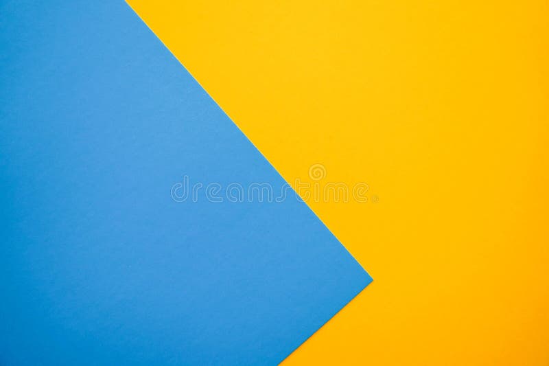 Lovely flat lay background with color paper sheets. Yellow and blue royalty free stock image