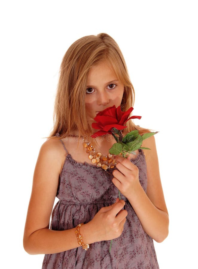 Lovely girl holding up a red roses.
