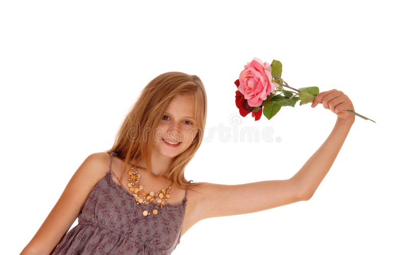 Lovely girl holding up two roses.