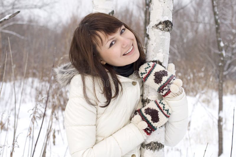 Lovely girl standing near birch