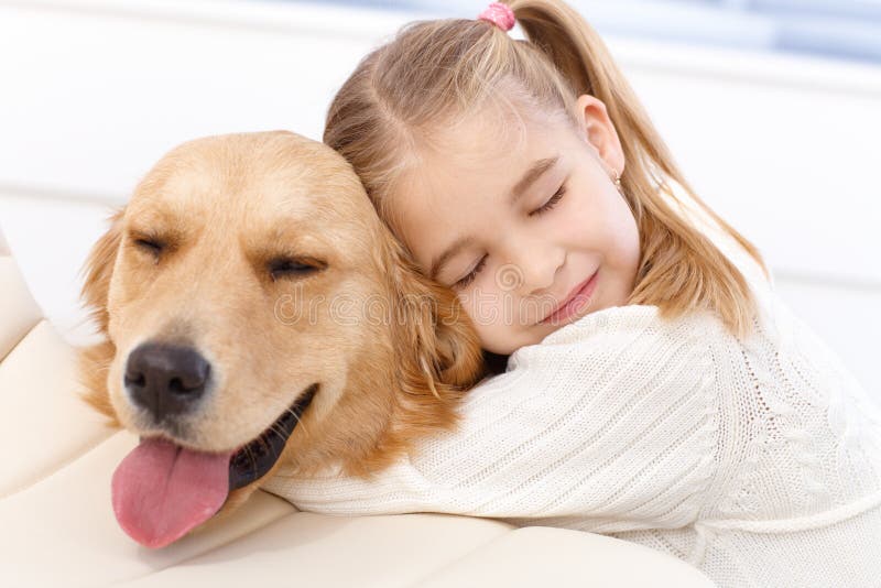 Lovely little girl hugging pet dog with passion, eyes closed. Lovely little girl hugging pet dog with passion, eyes closed.