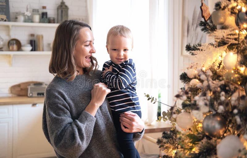 Lovely Mother And Child Posing Against Christmas Tree. royalty free stock image Lovely Mother And Child Posing Against Christmas Tree. royalty free stock image
