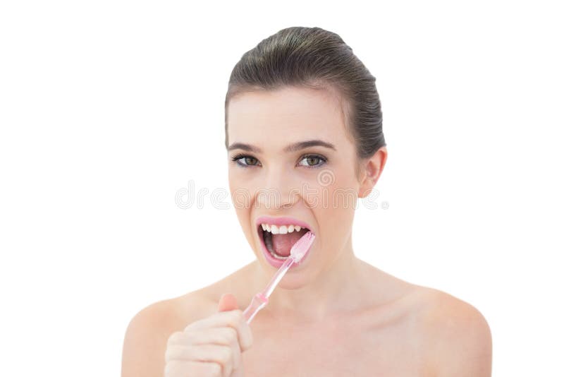 Lovely Natural Brown Haired Model Brushing Her Teeth Stock Photo