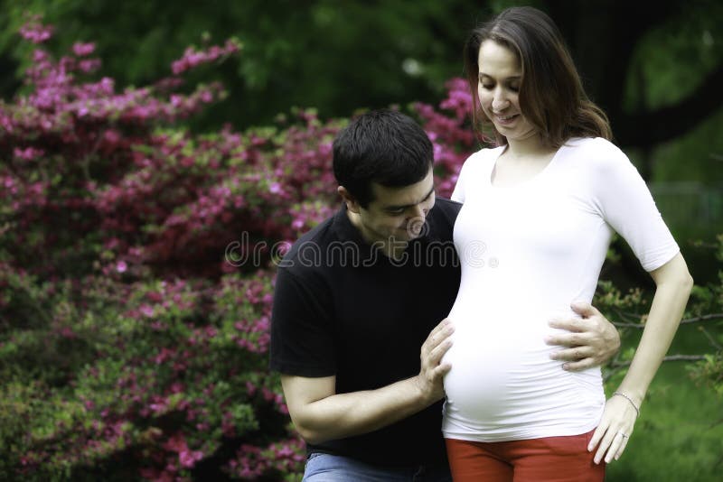 Lovely pregnant couple in nature