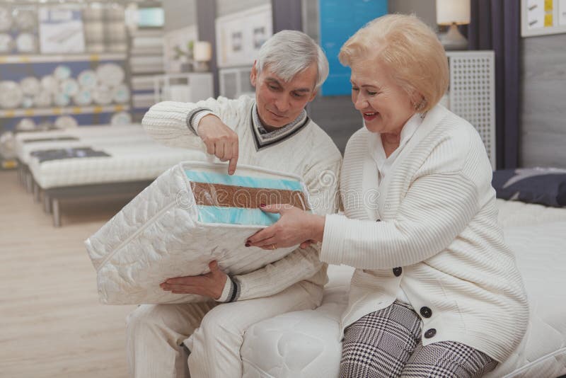 Lovely senior couple shopping at furniture store